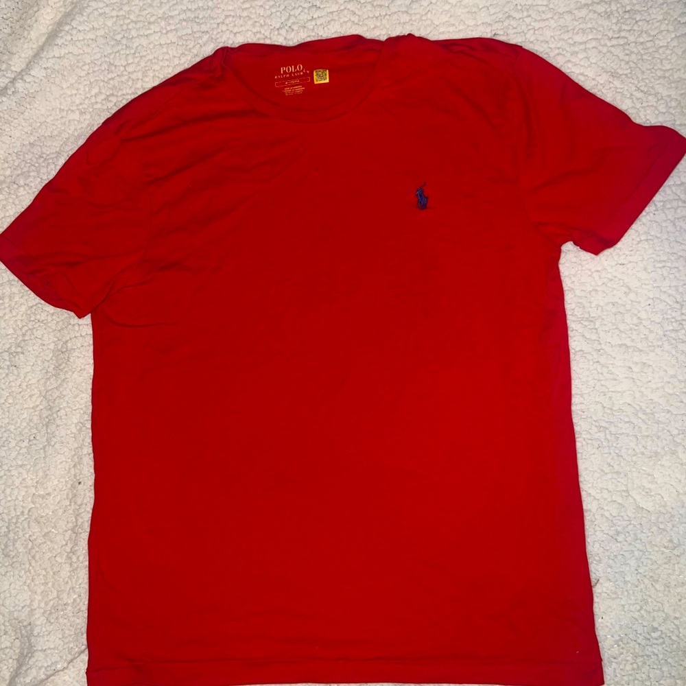 Red polo shirt with blue logo